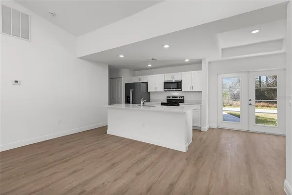 a view of kitchen with cabinets microwave and stove