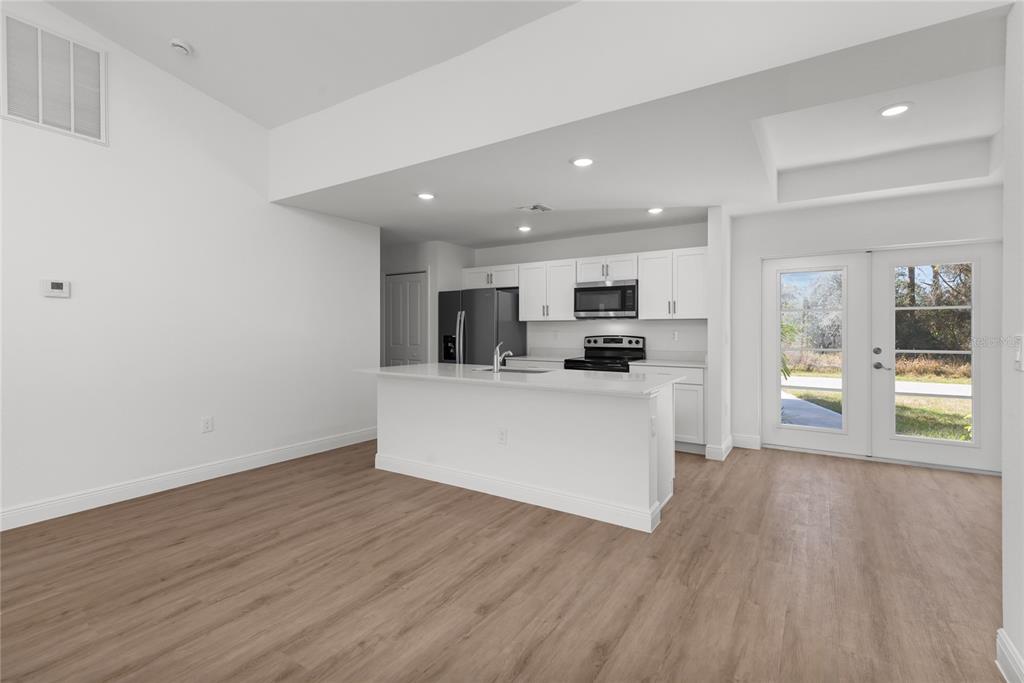107 Blue Road Rotonda West, FL 33947 - Photo 4 of 11 a view of kitchen with cabinets microwave and stove