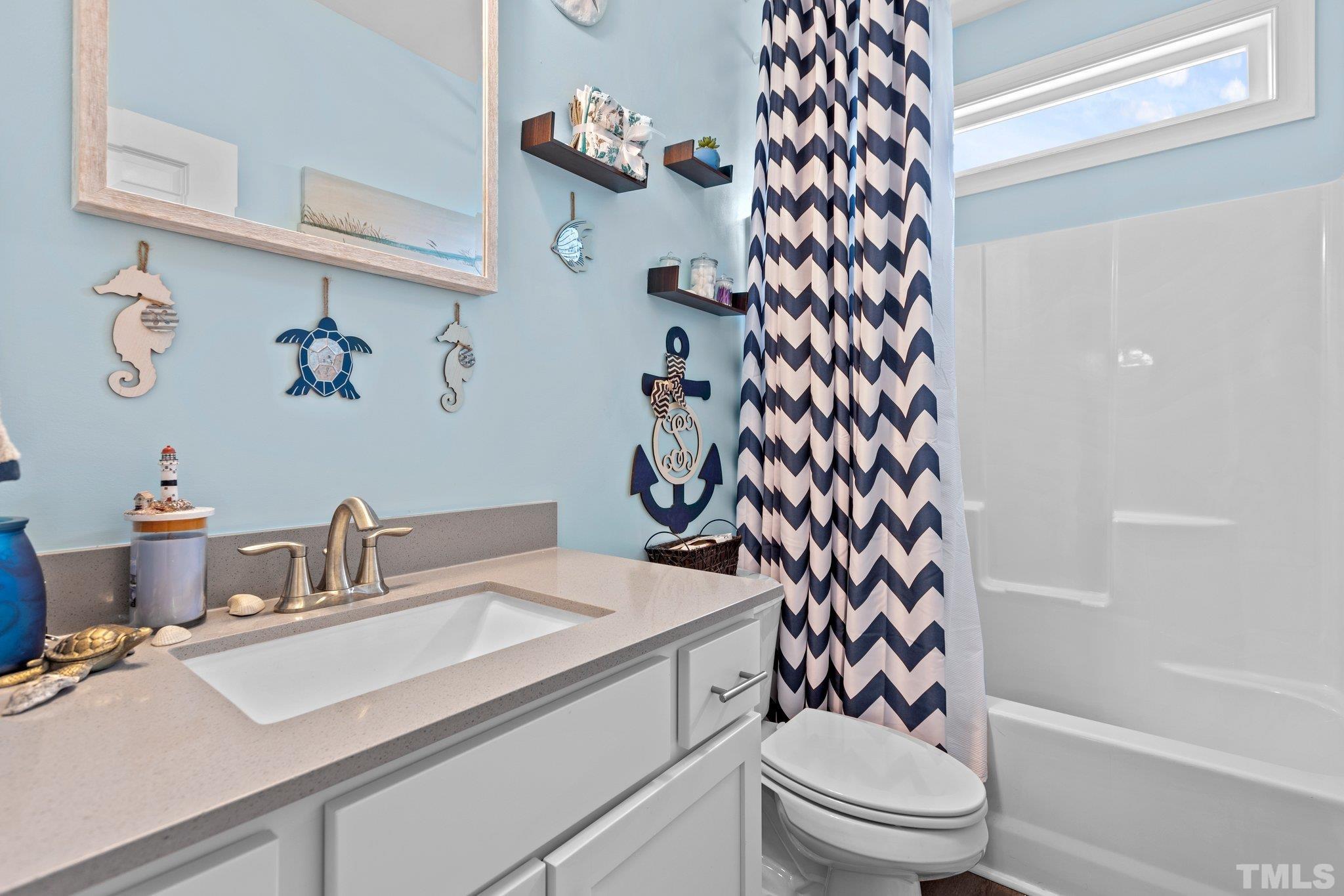 5338 Lloyd Road Lucama, NC 27851 - Photo 13 of 19 a bathroom with a sink a toilet and shower curtain