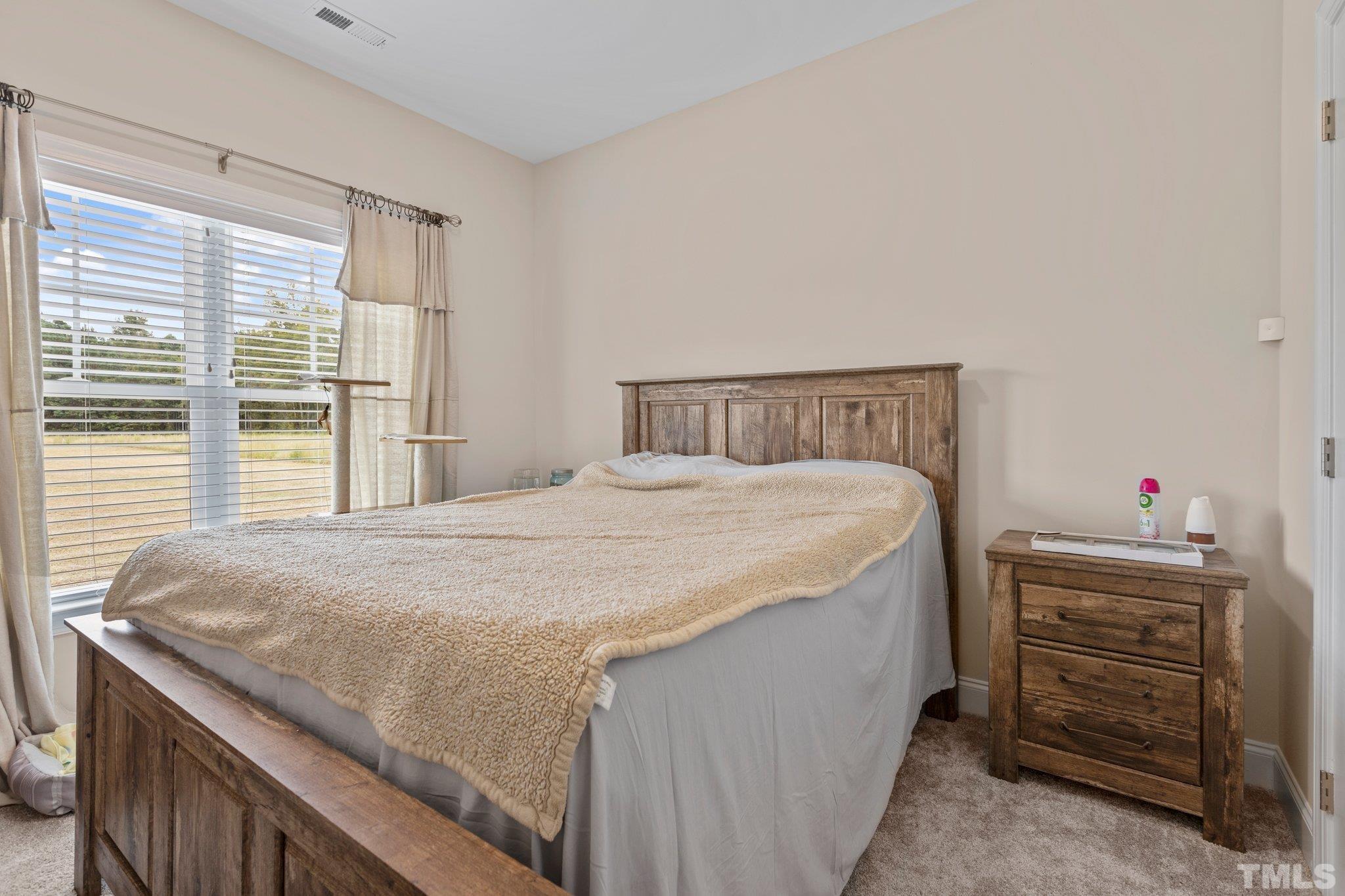 5338 Lloyd Road Lucama, NC 27851 - Photo 14 of 19 a bedroom with a bed and a dresser