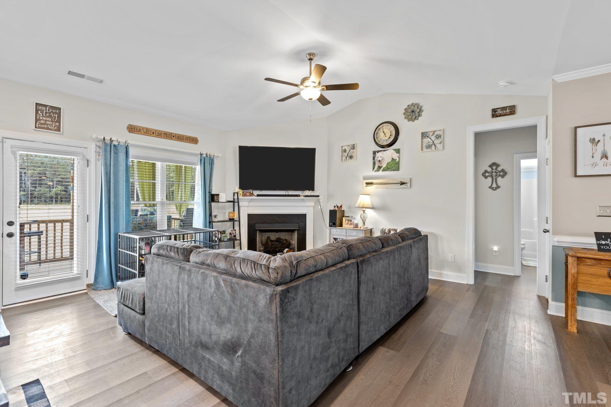 5338 Lloyd Road Lucama, NC 27851 - Photo 16 of 19 a living room with furniture a fireplace and a flat screen tv