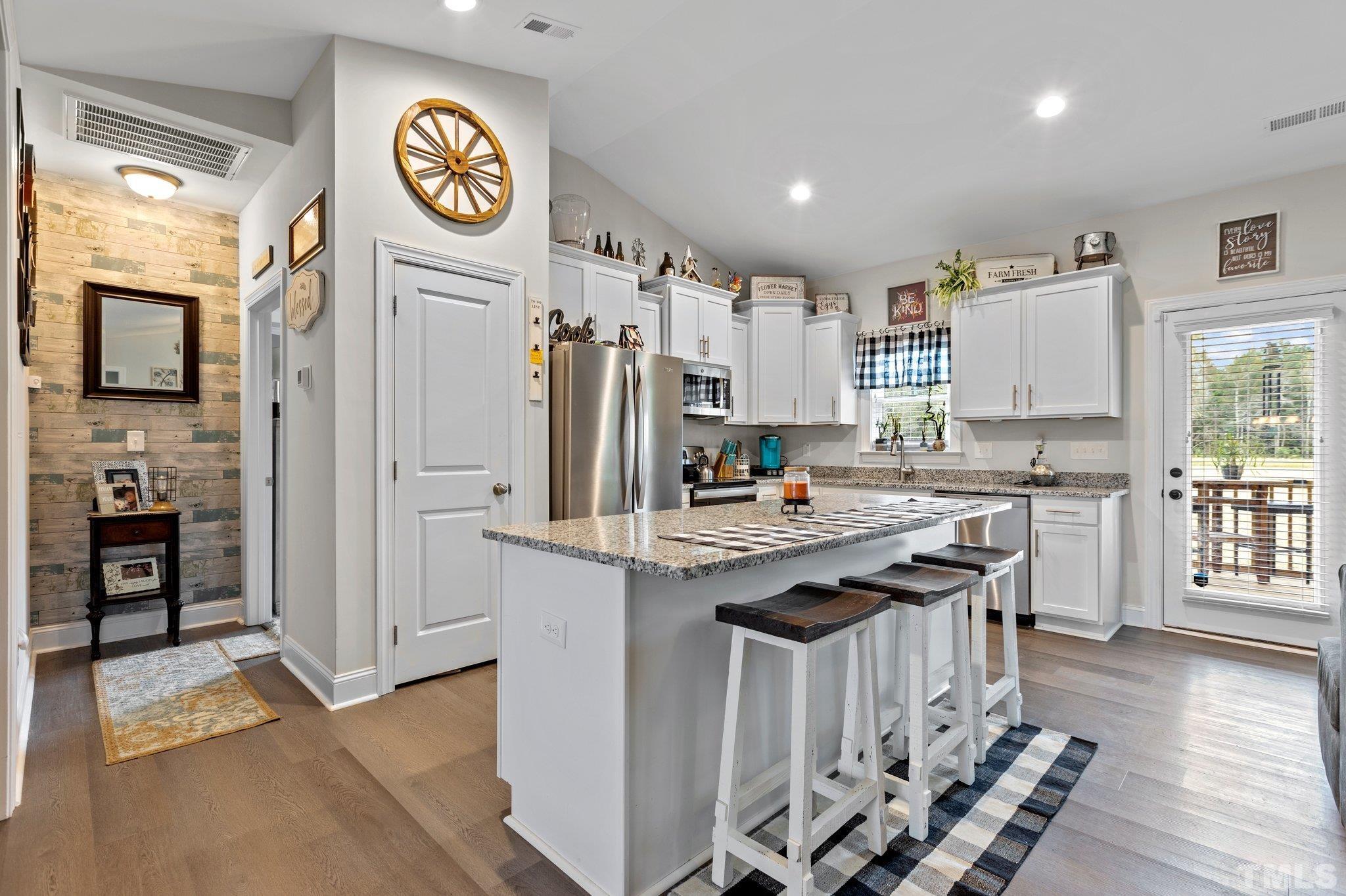 5338 Lloyd Road Lucama, NC 27851 - Photo 17 of 19 a kitchen with stainless steel appliances a stove refrigerator sink and cabinets