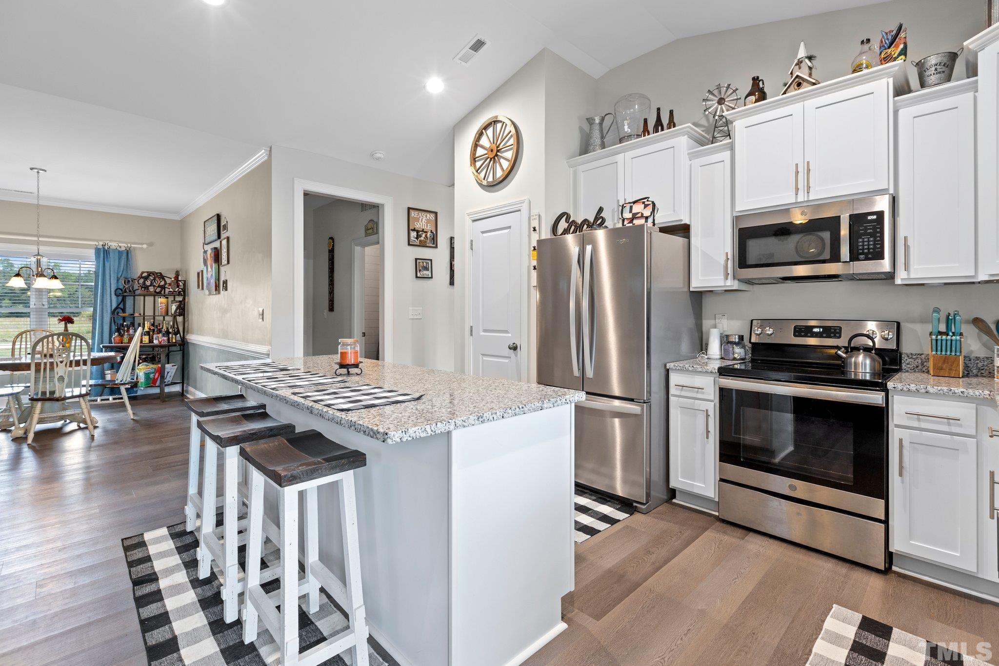 5338 Lloyd Road Lucama, NC 27851 - Photo 18 of 19 a kitchen with stainless steel appliances granite countertop a refrigerator a stove top oven a sink and dishwasher