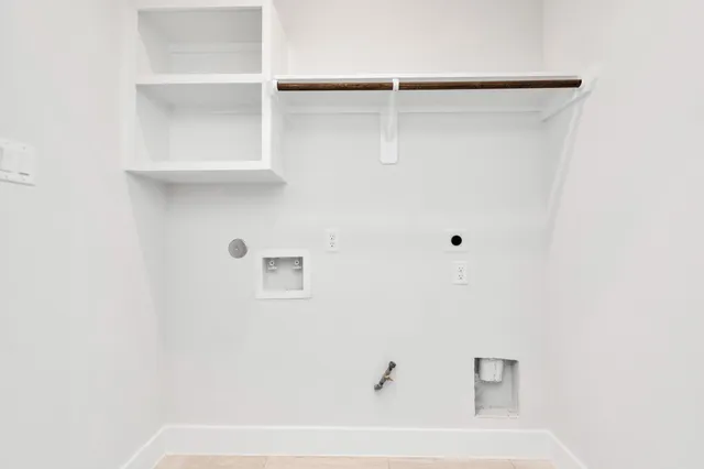an empty room with a bathroom and a sink