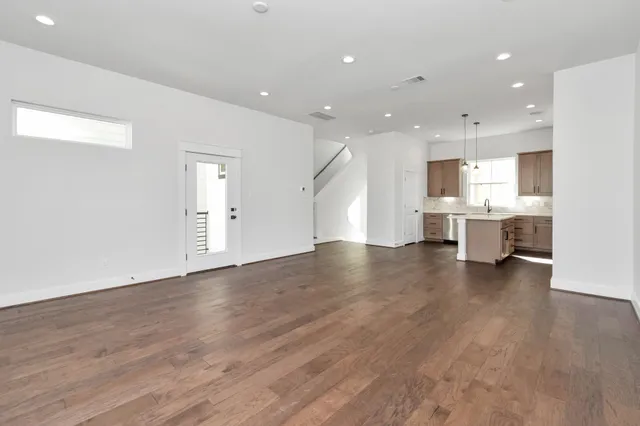 a view of a kitchen with cabinets and wooden floor