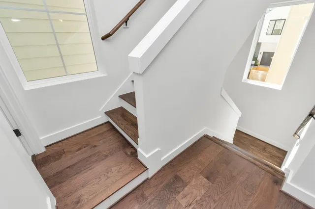 a view of entryway and hall with wooden floor