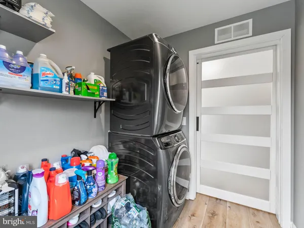 a utility room with lots of clutter and cabinets