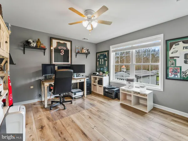 a view of a workspace with furniture and a window