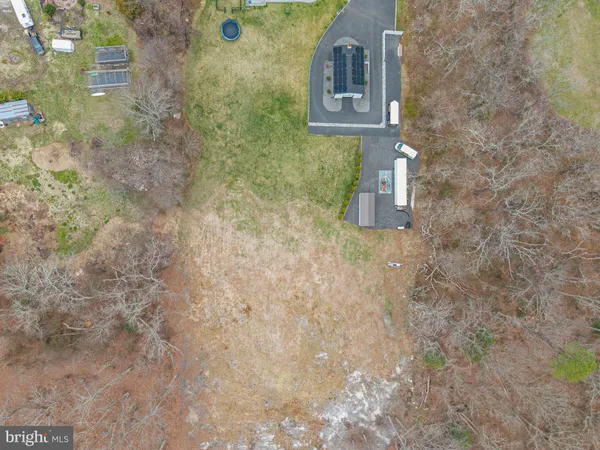 an aerial view of a residential houses with outdoor space