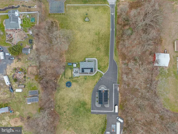 an aerial view of a house with a yard