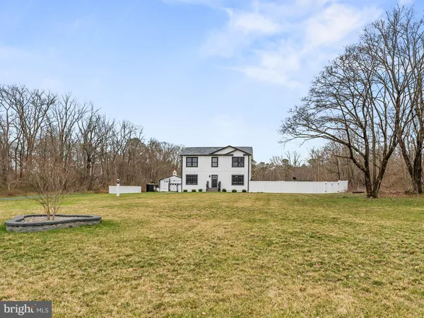 a view of a yard with a house in the background