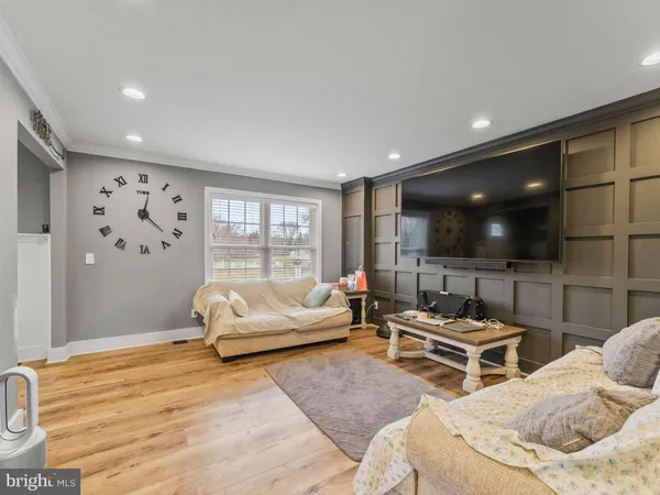 a spacious bedroom with two beds and a flat screen tv