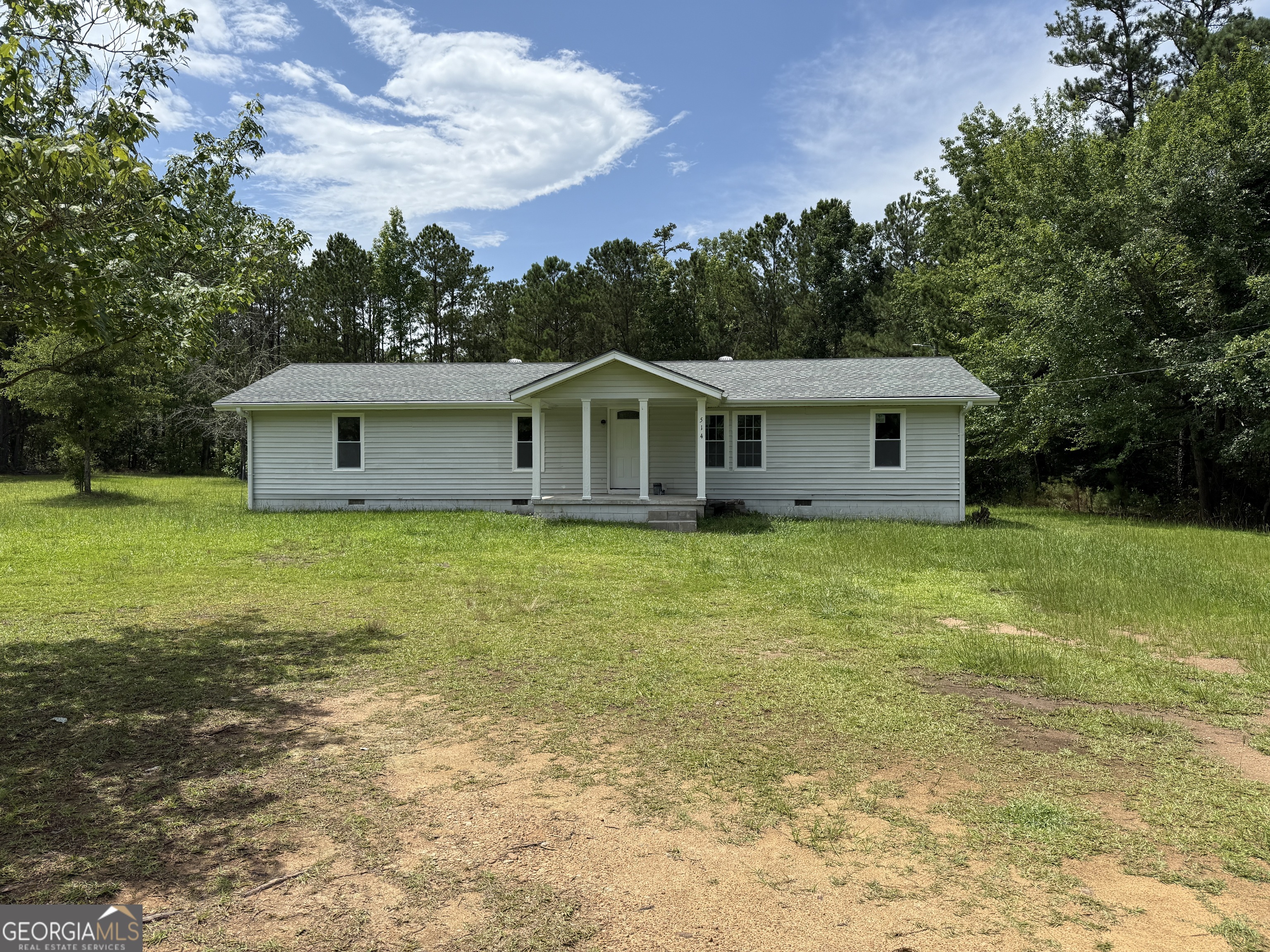 a view of a house with a backyard