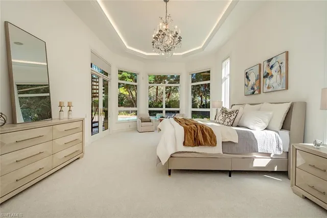 a spacious bedroom with a bed and a large window