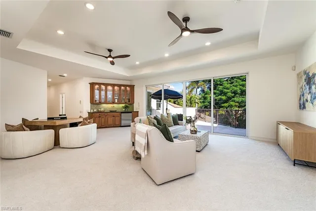 a living room with fireplace furniture and a large window