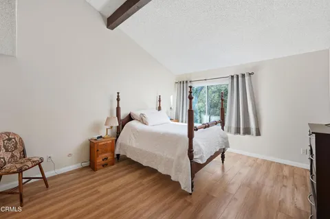 a bed room with a bed and a chair