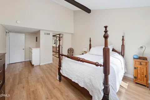 a bed room with a bed and wooden floor