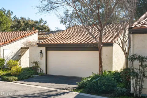 a view of a house with a yard and garage
