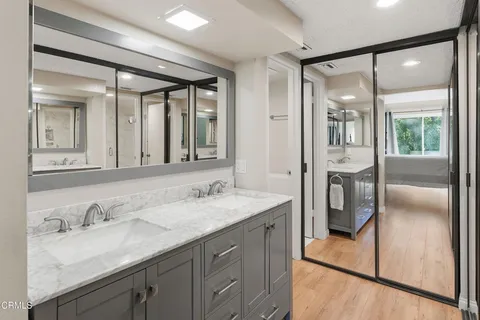 a bathroom with a granite countertop sink mirror and double