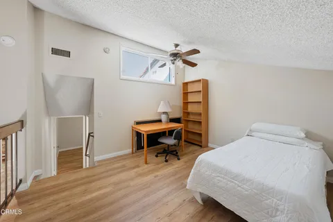 a bedroom with a bed and a table in it