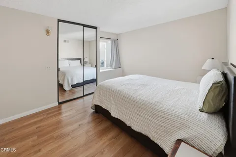 a bedroom with a bed and wooden floor