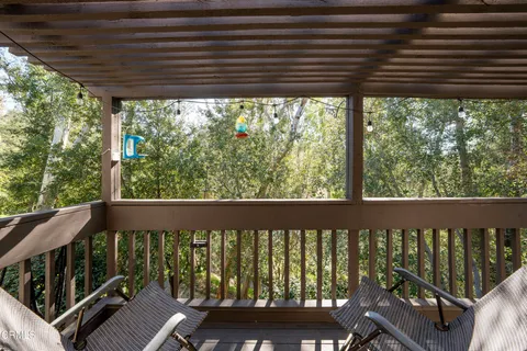 a view of a balcony with wooden floor