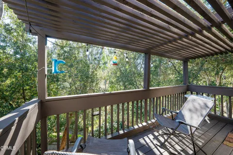 a view of a two chairs in the balcony