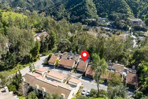 an aerial view of a house with a yard and street view