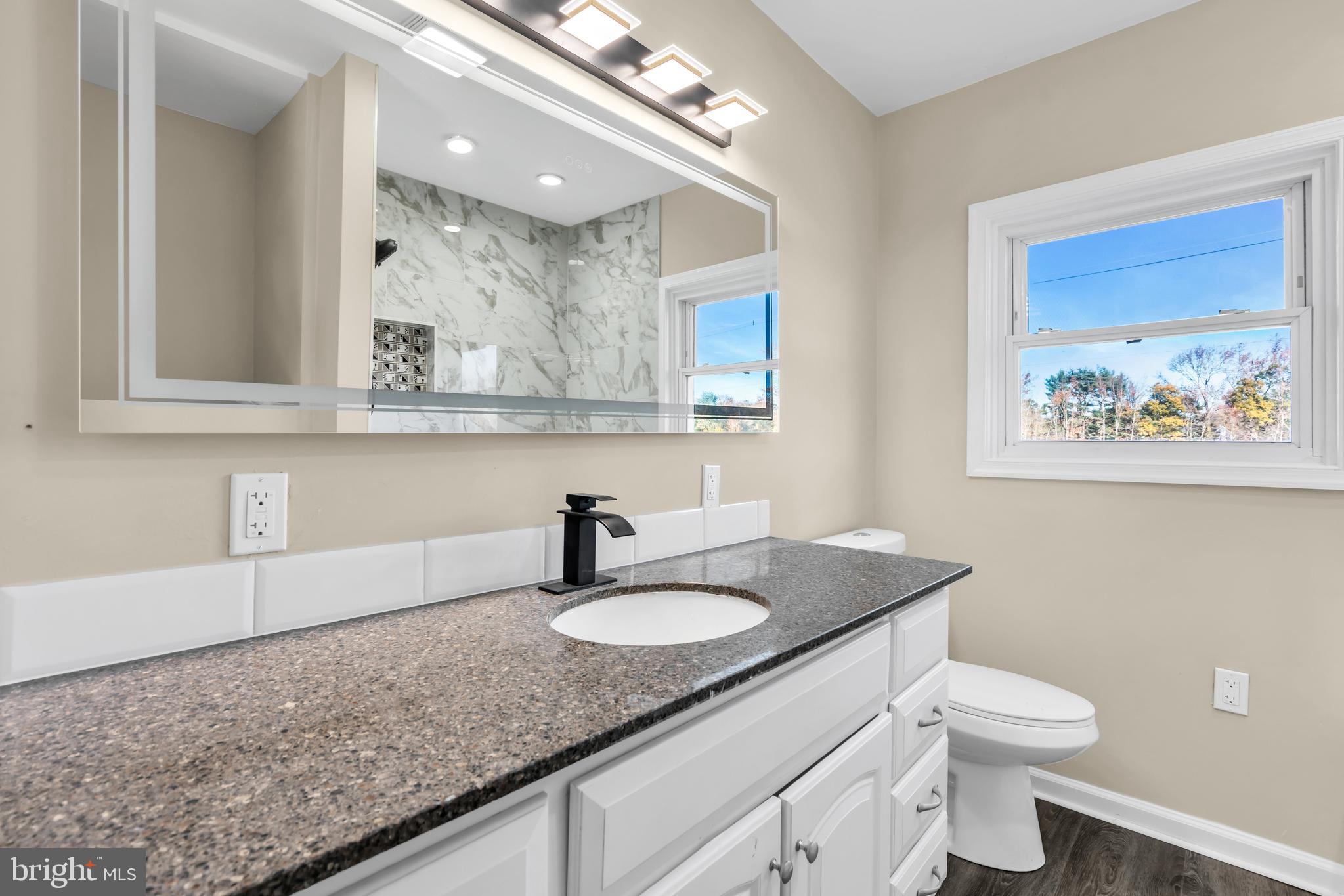 86 Scrapetown Road Pemberton, NJ 08068 - Photo 26 of 43 a bathroom with a granite countertop sink a toilet and a mirror