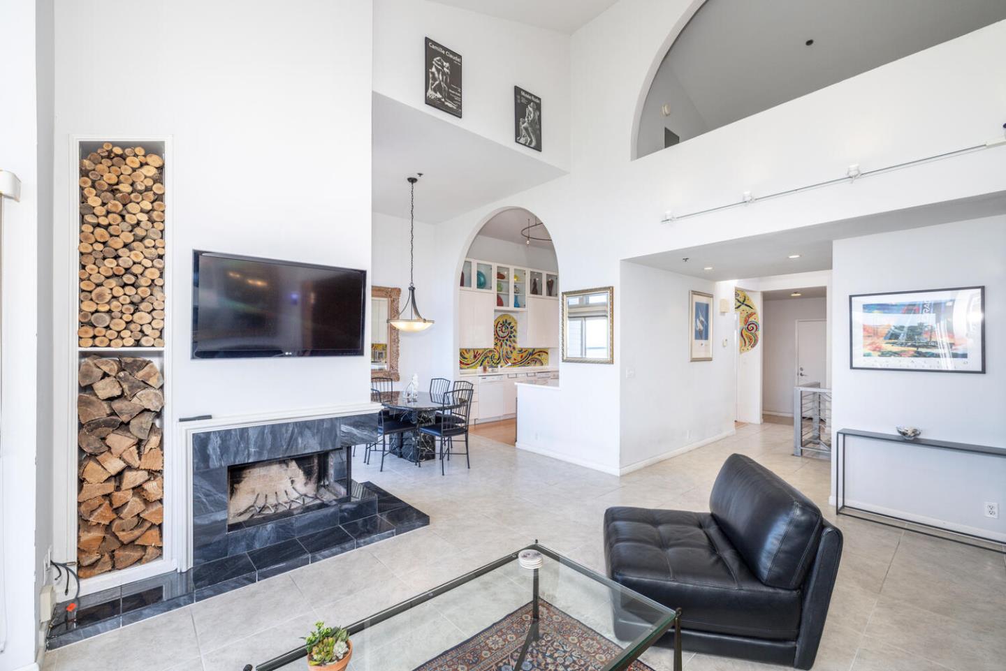 211 Roberts Road Pacifica, CA 94044 - Photo 28 of 42 a living room with furniture a flat screen tv and a fireplace