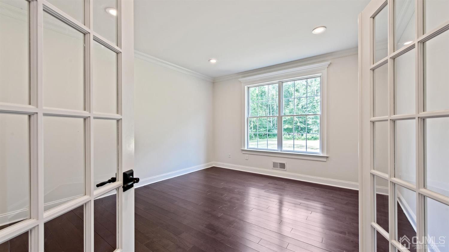 152 Culver Road Monmouth Junction, NJ 08852 - Photo 11 of 87 a view of an empty room with wooden floor and a window
