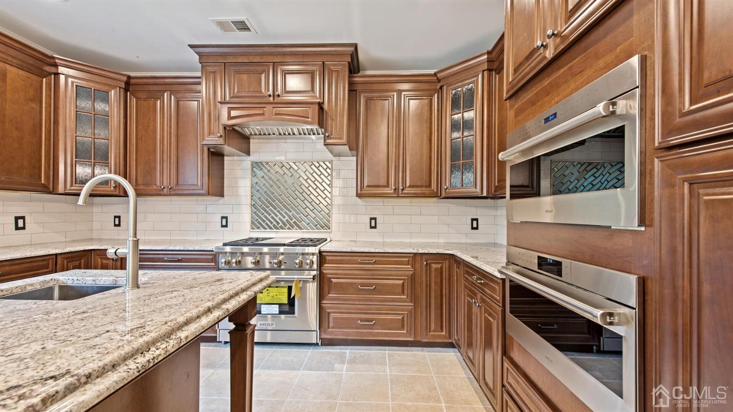 152 Culver Road Monmouth Junction, NJ 08852 - Photo 29 of 87 a kitchen with a sink stove and cabinets