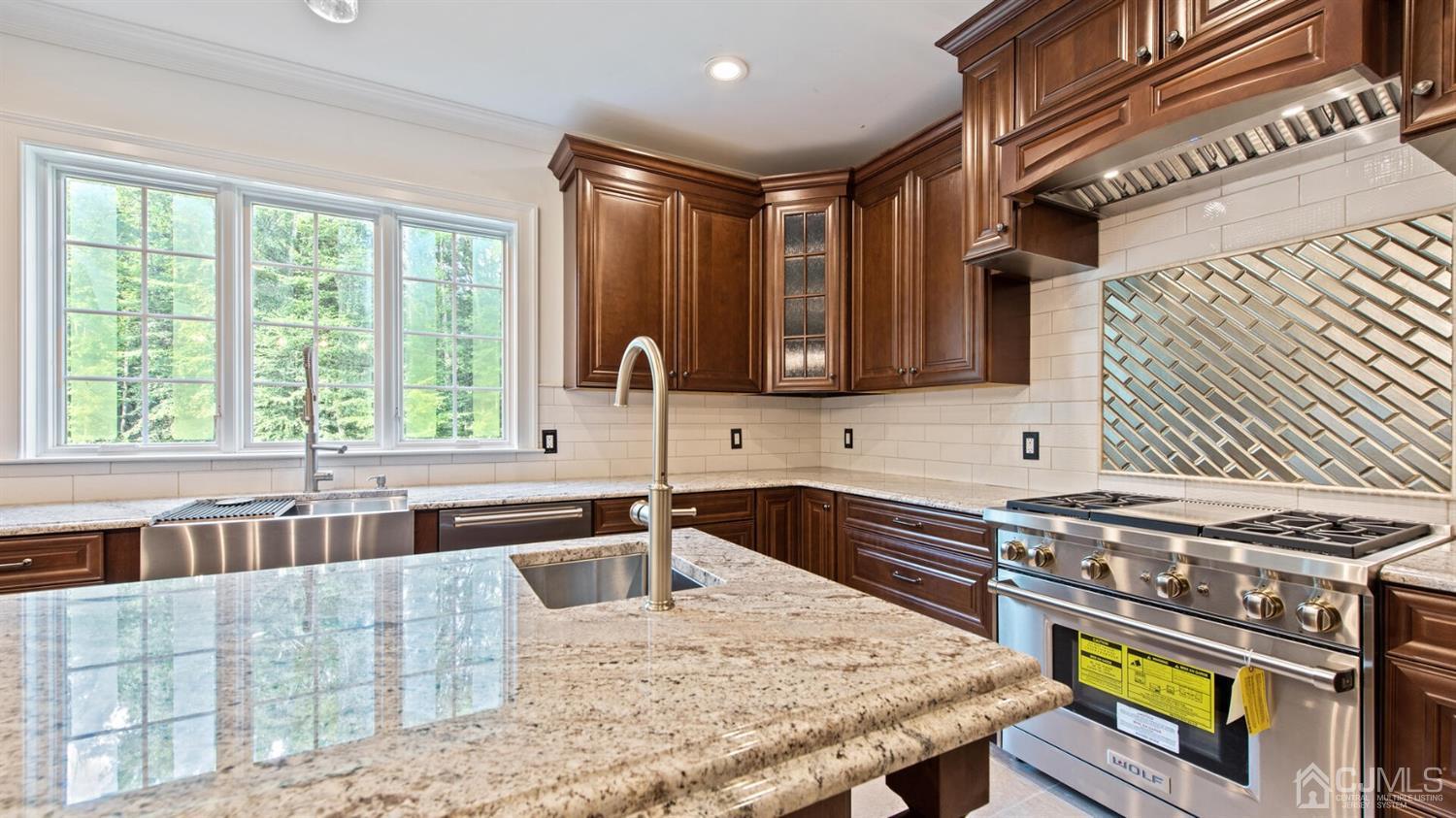 152 Culver Road Monmouth Junction, NJ 08852 - Photo 30 of 87 a kitchen with stainless steel appliances granite countertop a sink a stove and a wooden cabinets