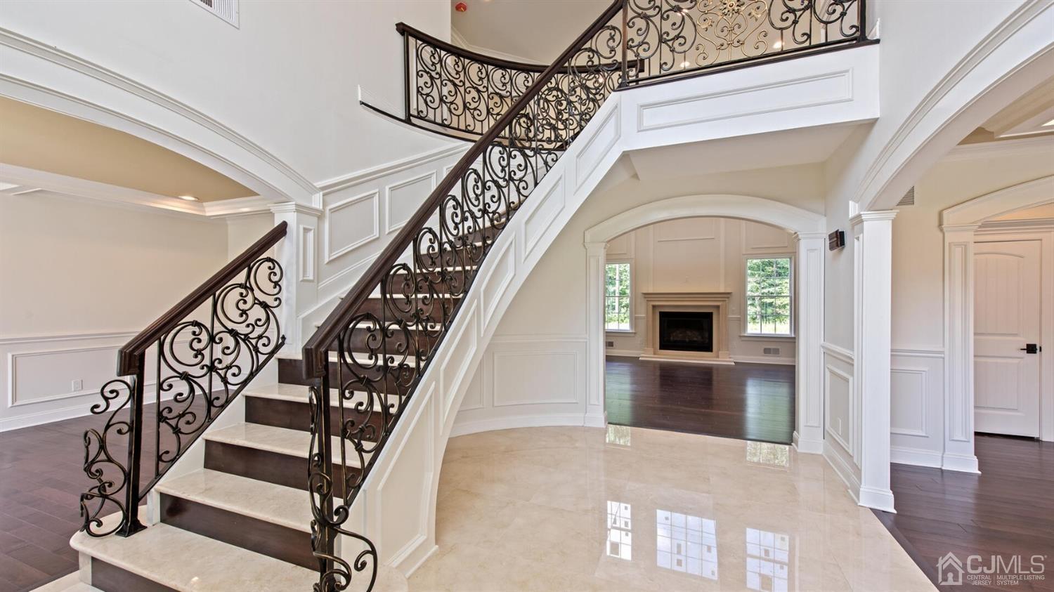 152 Culver Road Monmouth Junction, NJ 08852 - Photo 6 of 87 Custom staircase, wrought iron railings and a beautiful entry with Crema Marfil marble tile welcomes you home.