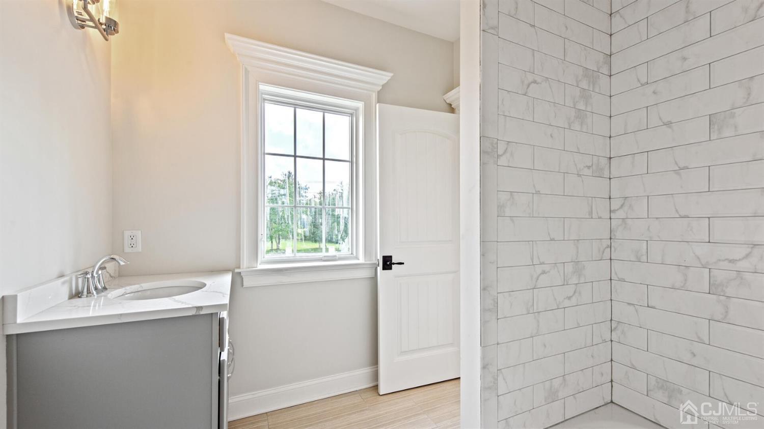 152 Culver Road Monmouth Junction, NJ 08852 - Photo 66 of 87 a bathroom with a granite countertop sink a shower and a window