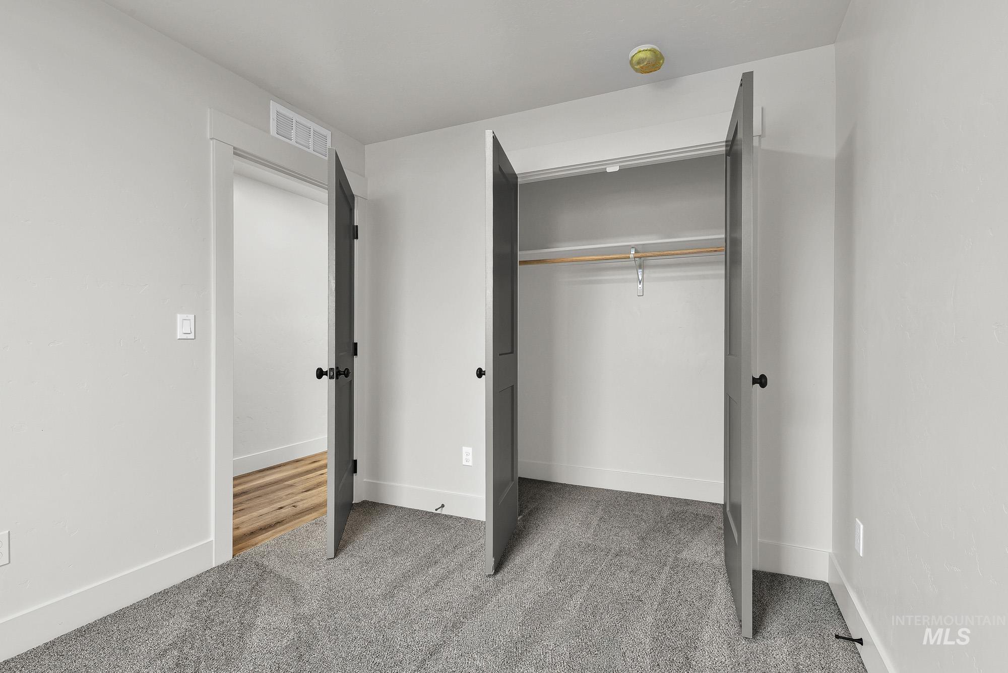 323 North 12th Street Parma, ID 83660 - Photo 20 of 28 Unfurnished bedroom featuring light colored carpet and a closet