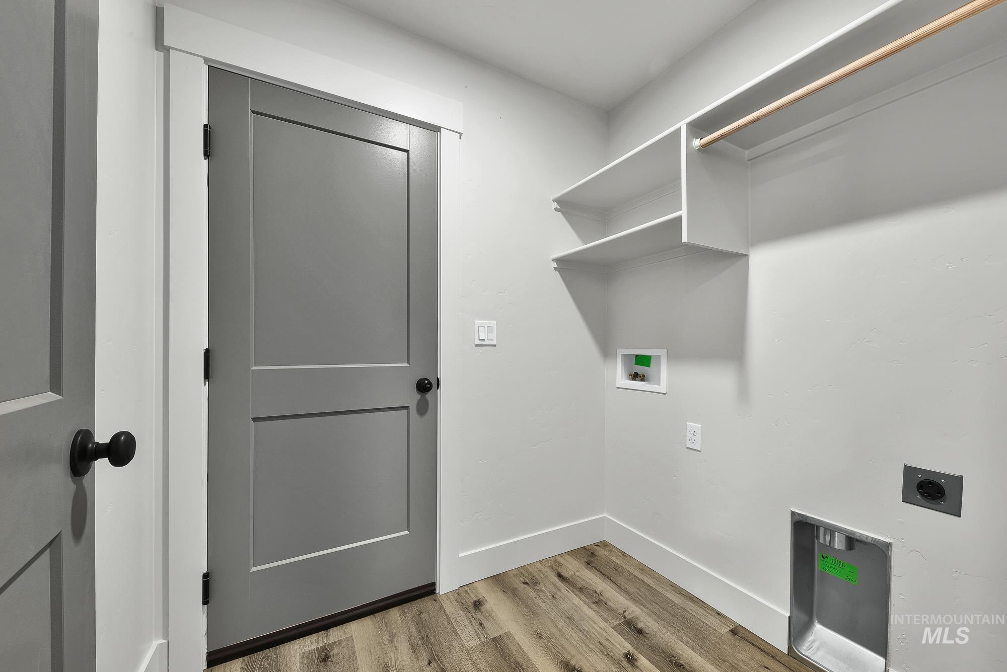 323 North 12th Street Parma, ID 83660 - Photo 24 of 28 Laundry room featuring light wood-style flooring, washer hookup, and electric dryer hookup