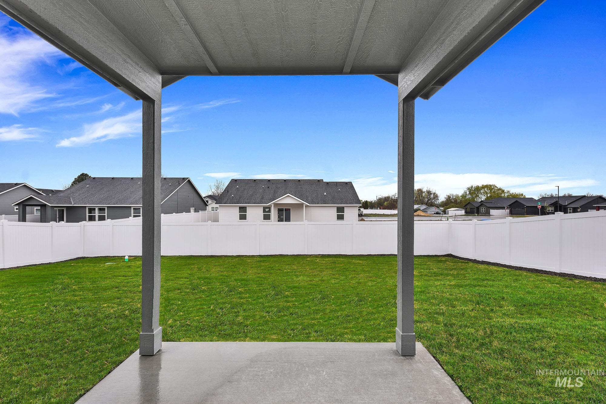 323 North 12th Street Parma, ID 83660 - Photo 25 of 28 Fenced backyard with a patio and a residential view
