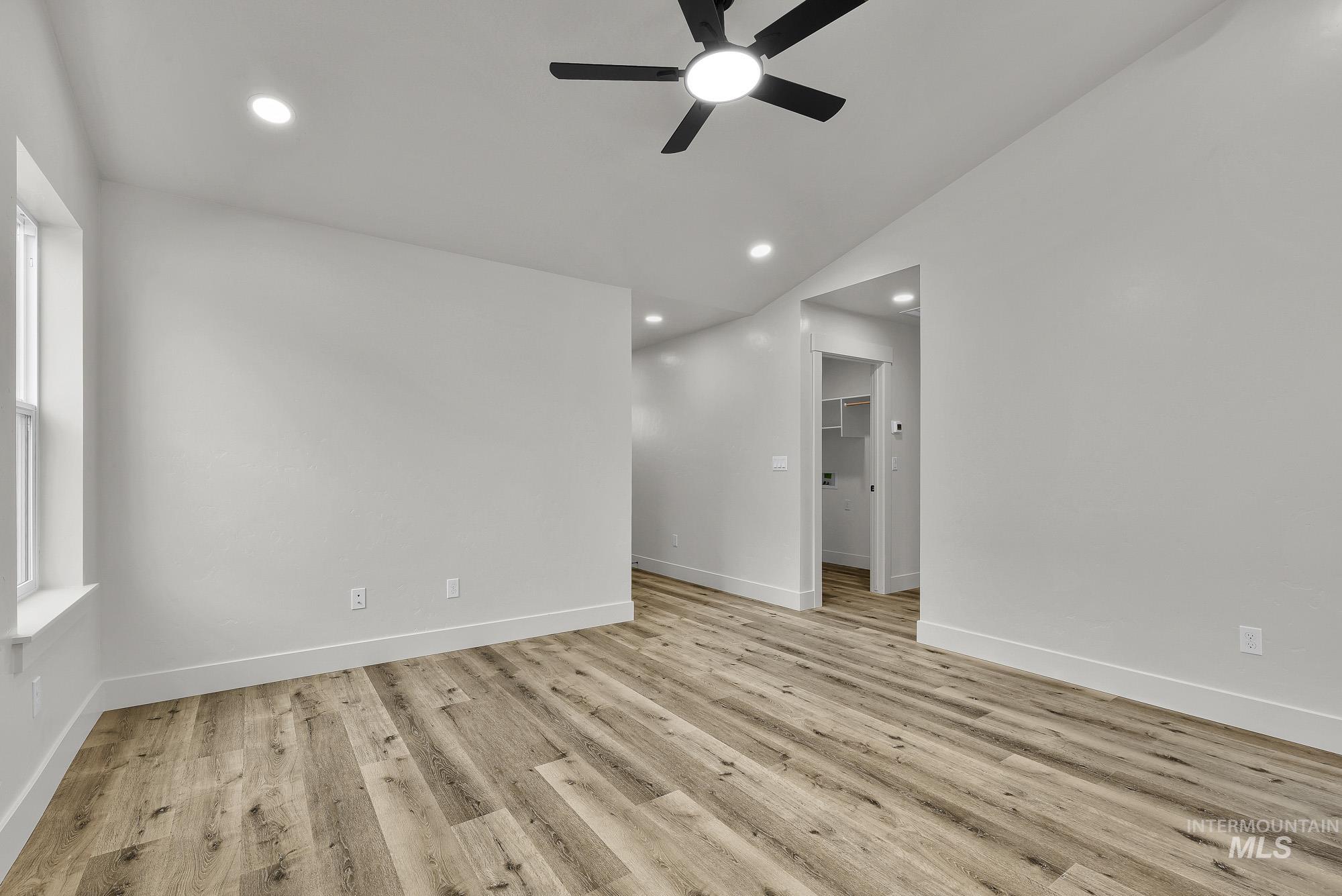 323 North 12th Street Parma, ID 83660 - Photo 6 of 28 Unfurnished room featuring a ceiling fan, light wood finished floors, lofted ceiling, and recessed lighting