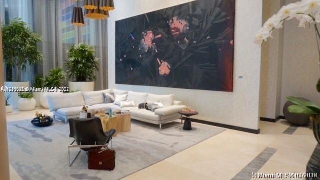 55 Southwest 9th Street, Unit 3307 Miami, FL 33130 - Photo 15 of 16 a living room with furniture and flowers