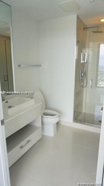 55 Southwest 9th Street, Unit 3307 Miami, FL 33130 - Photo 7 of 16 a bathroom with a sink a toilet and shower