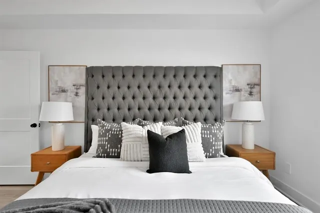 a bedroom with a bed and a lamp