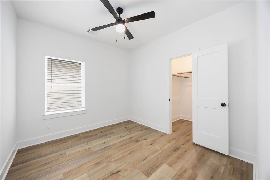 8019 Cora Street, Unit A Houston, TX 77088 - Photo 21 of 25 a view of an empty room with wooden floor and a window