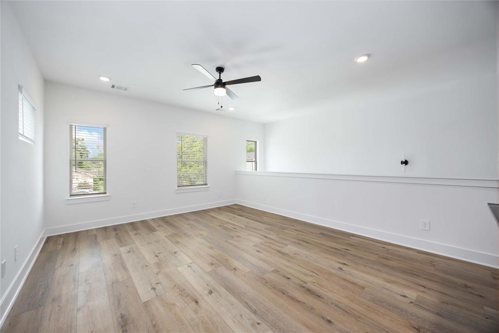 8019 Cora Street, Unit A Houston, TX 77088 - Photo 9 of 25 a view of empty room with wooden floor and fan
