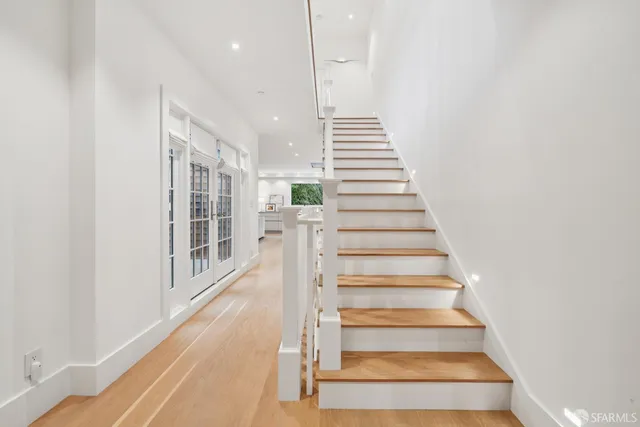wooden floor with a large mirror and a window