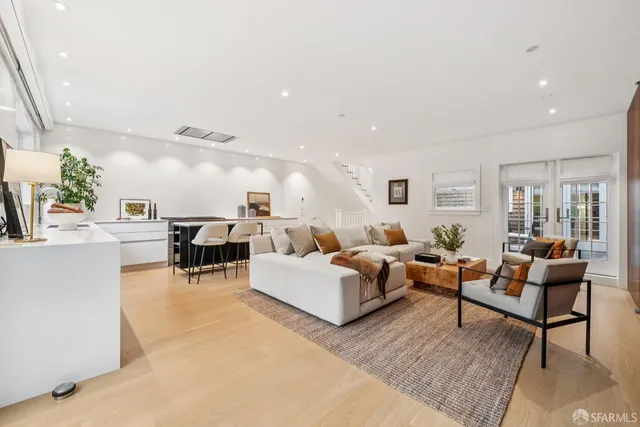 a view of a hallway to a livingroom with furniture