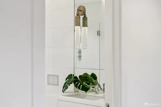 a view of a hallway to a livingroom with furniture