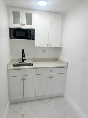 a kitchen with a sink and cabinets