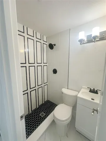 a bathroom with a toilet and a shower