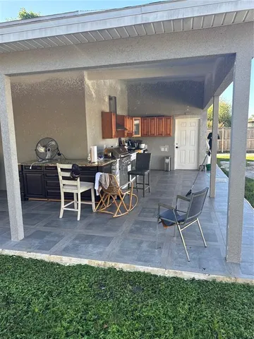 a view of a dining room with furniture and a potted plant